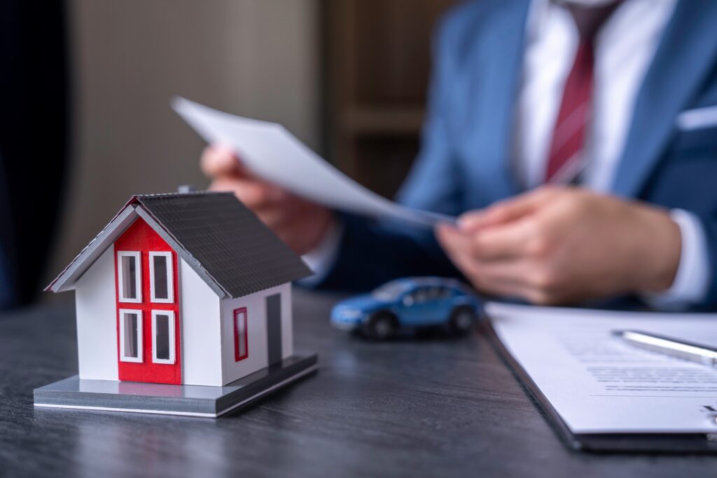 Businessman reading contract documents for purchase and home insurance home insurance concept, home